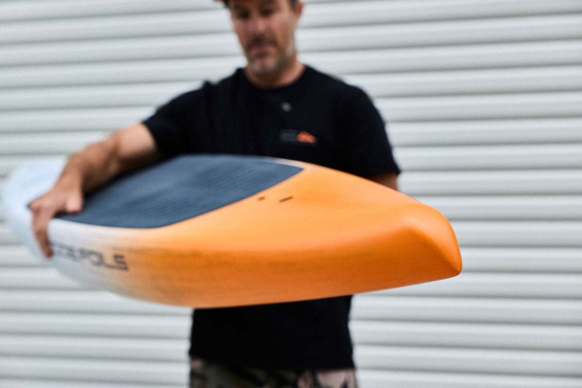 Orange tail of the Downwind SUP board held towards the camera