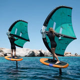 Two people on wingsurfing on Duotone Sky Free Foilboards with Duotone Unit wings in a body of water in Sardinia