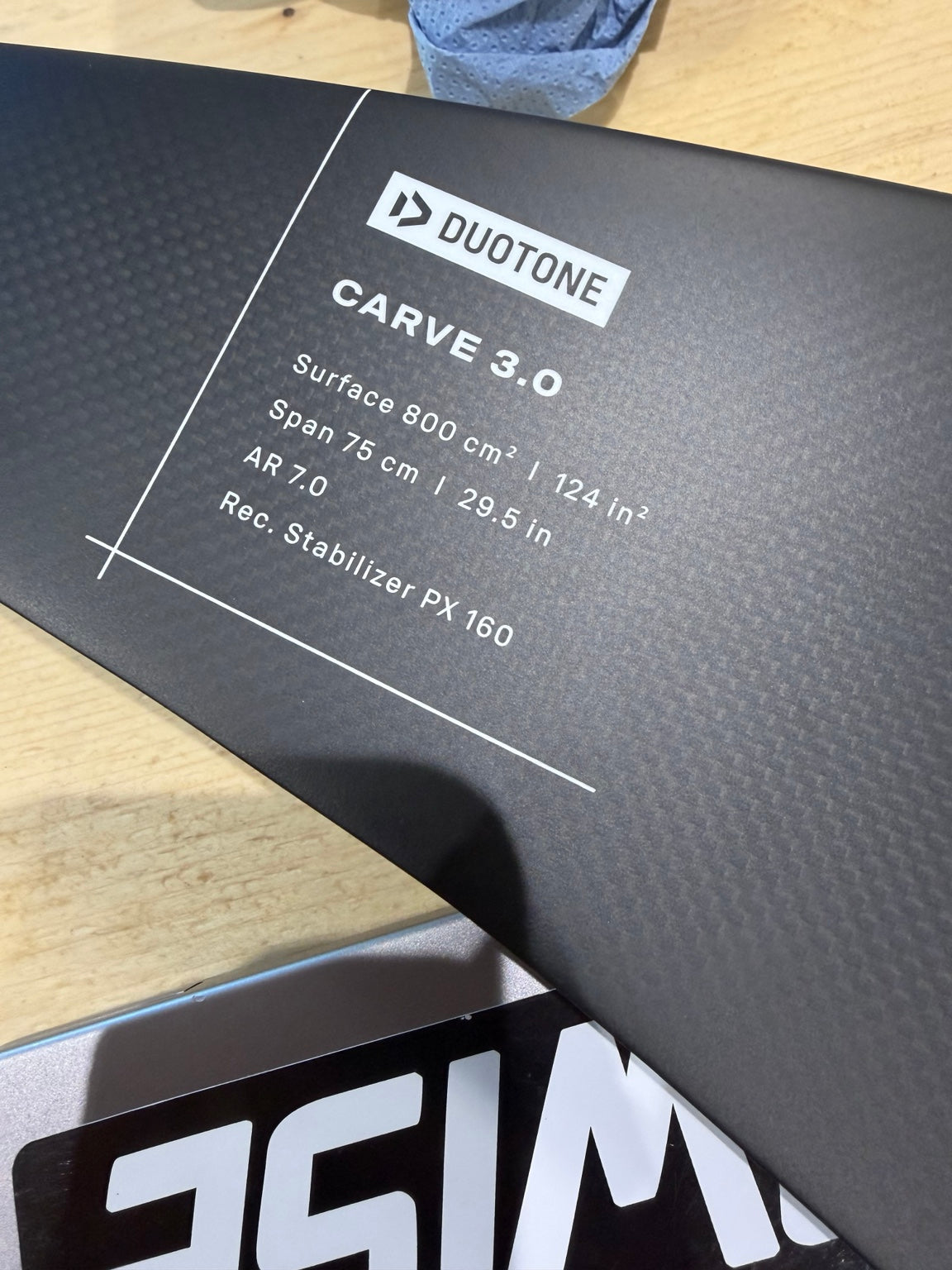 Actual ex-demo Duotone Carve 3.0 SLS 800 front wing showing carbon surface and printed 800cm² specifications