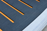 Close view of the Prone board textured deck pad and orange grooves
