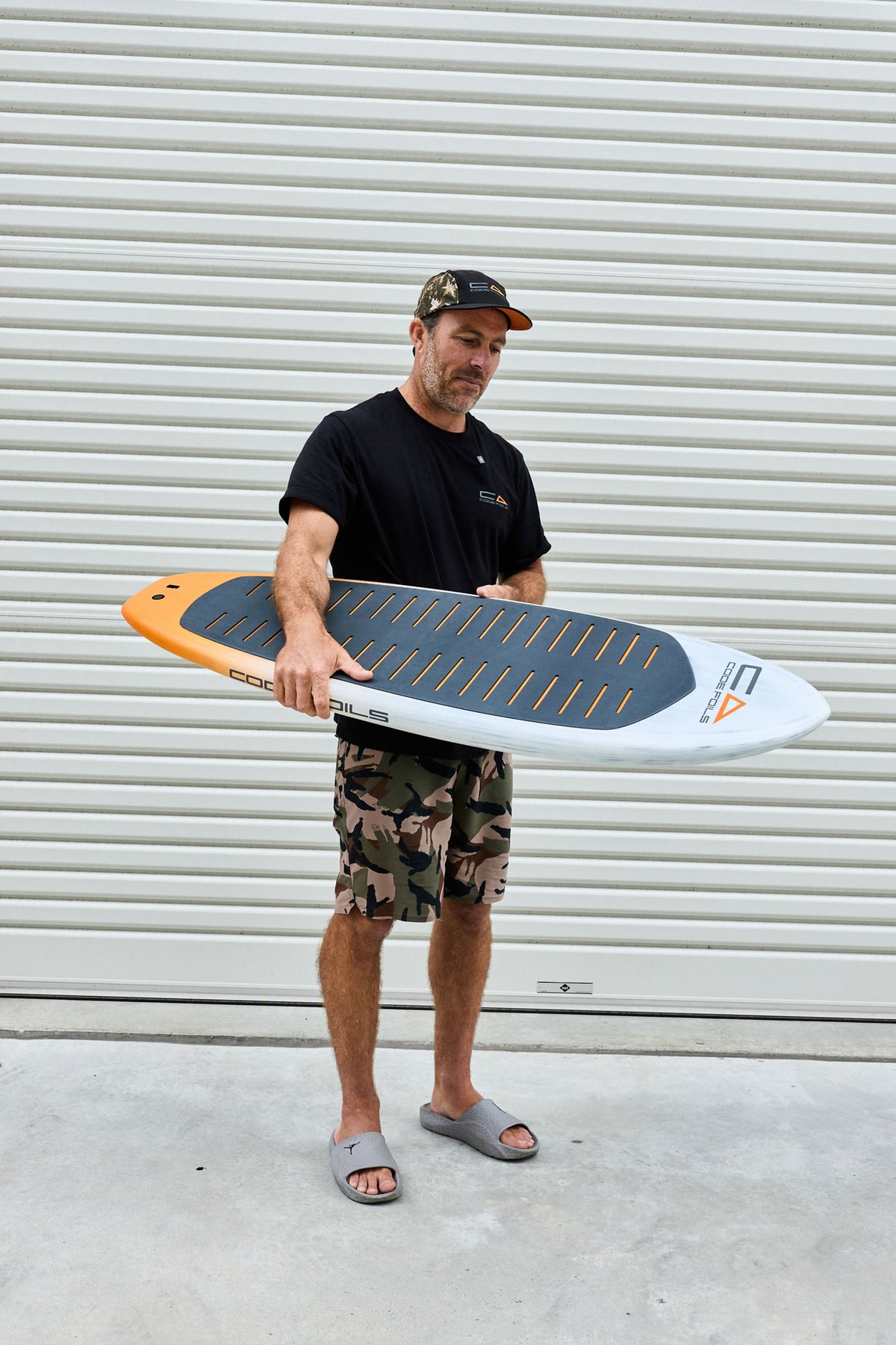 Code Foils Prone board held at an angle showing the deck and rail
