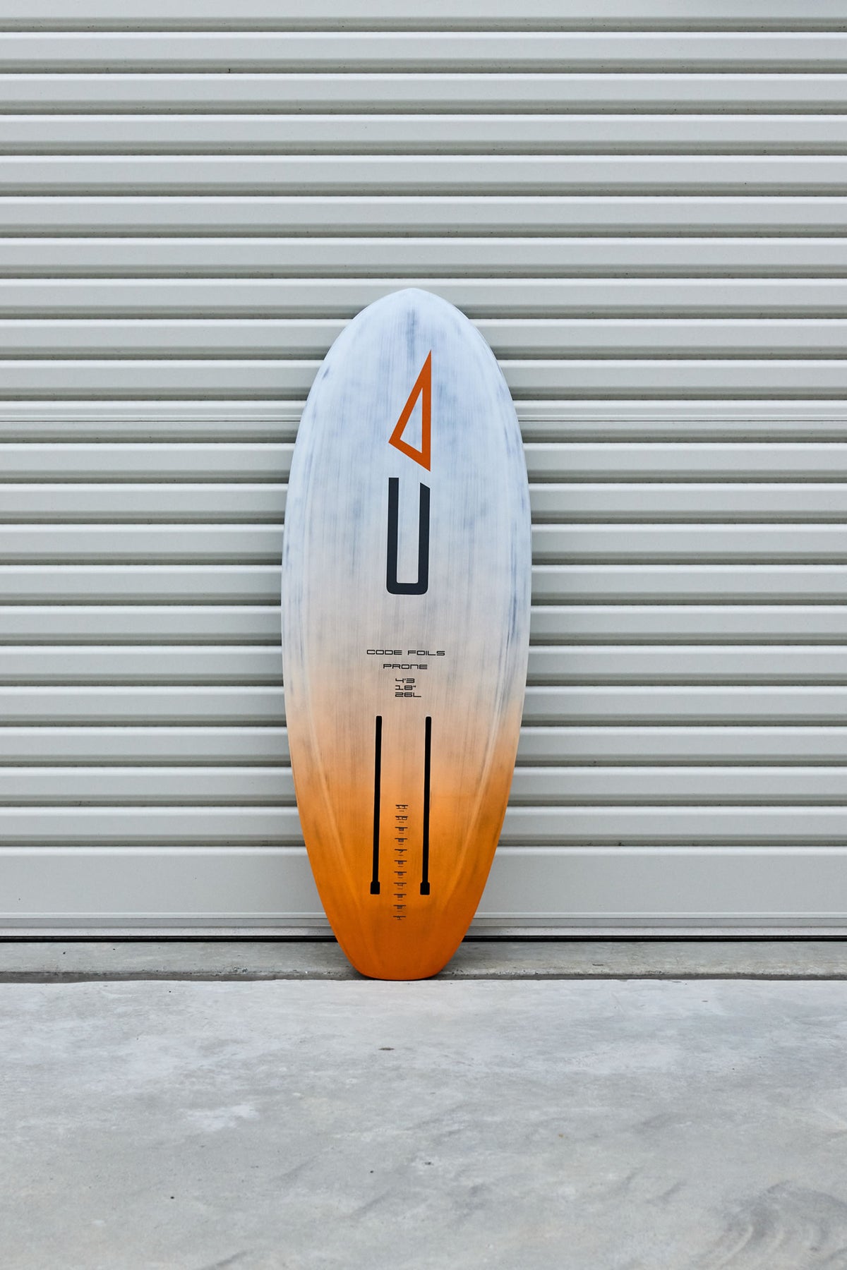 Full underside view of the Code Foils Prone board and twin foil tracks