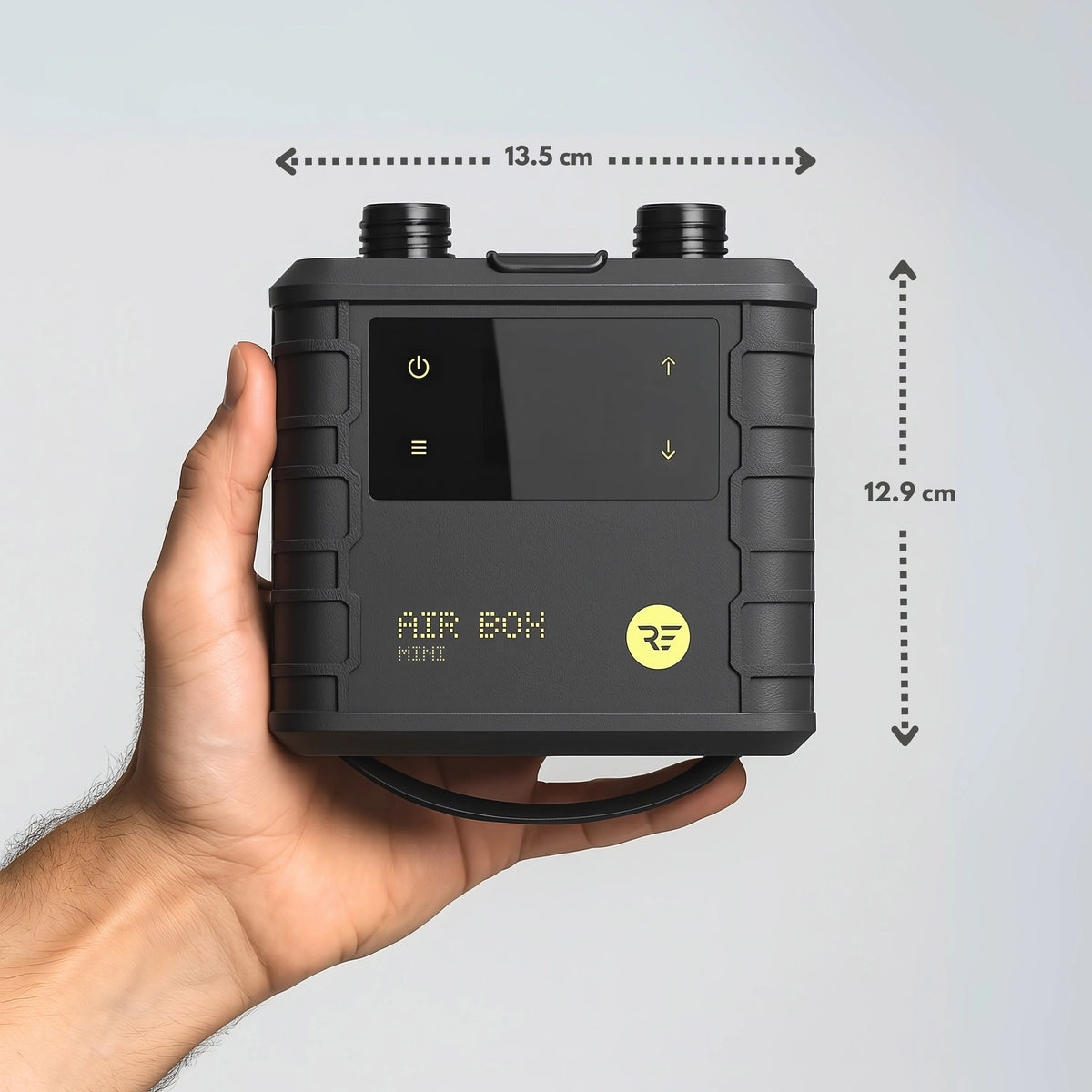 Ride Engine Air Box Mini electric pump in a hand showing compact size for kit bags and travel